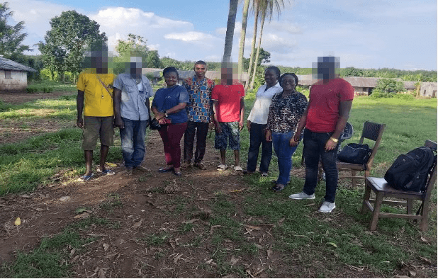 Group of community members and TRACH team members standing together