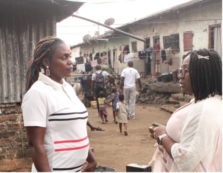 TRACH team member having one-on-one sensitization discussion with a community woman
